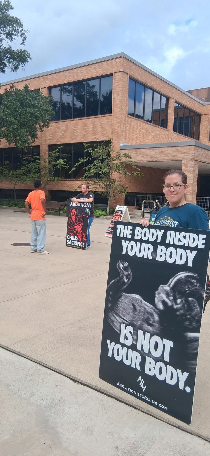 Outreach on a campus sidewalk with an ultrasound sign
