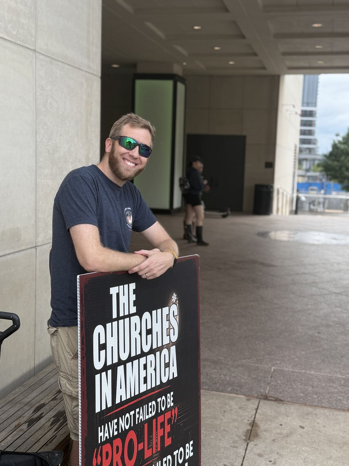 A man with a sign about the churches in America and the pro-life movement